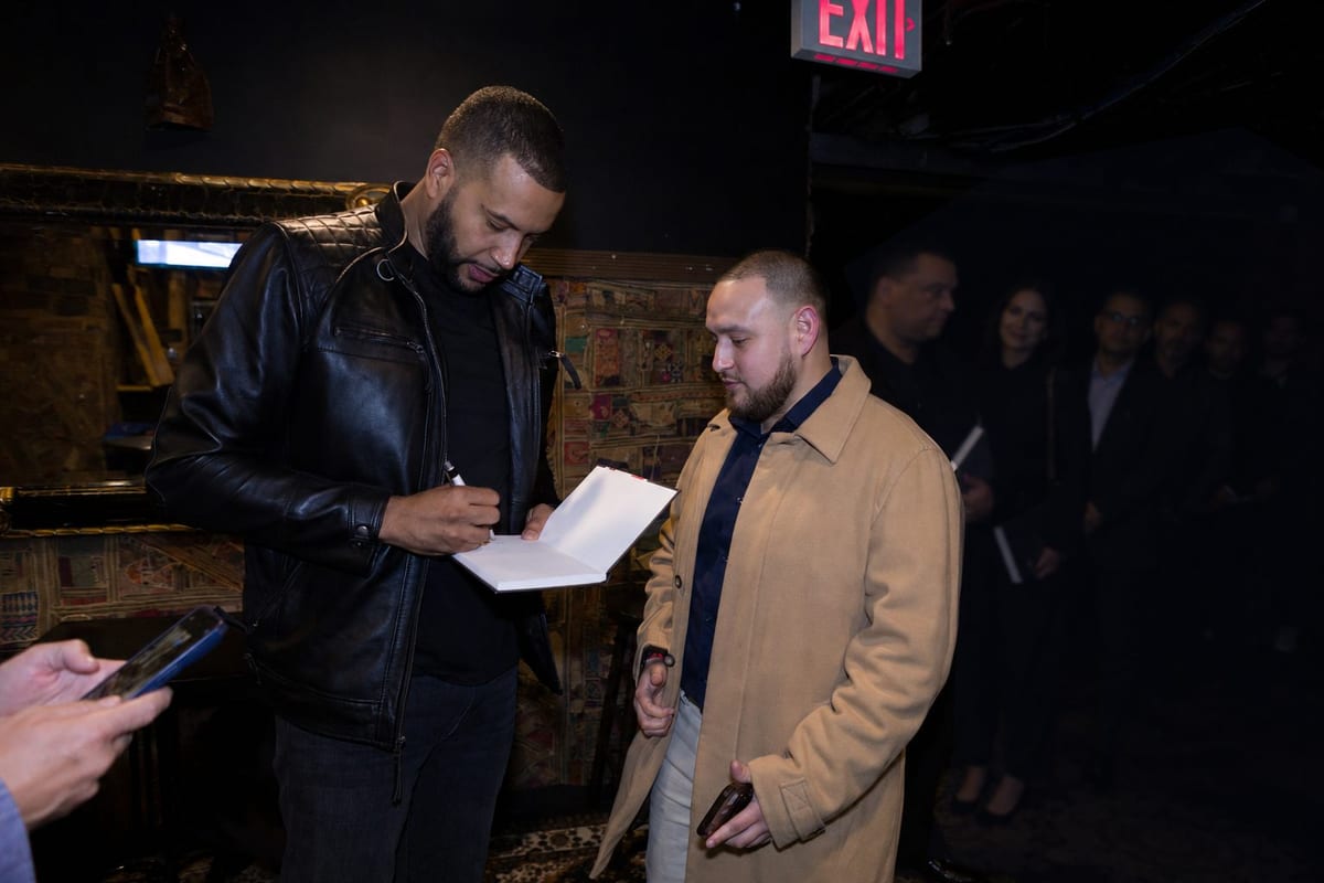 Armando signing a book after the show